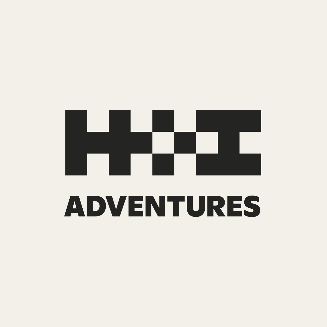 H+I Adventures logo featuring a checkered pattern and bold text. Mountain Bike United.