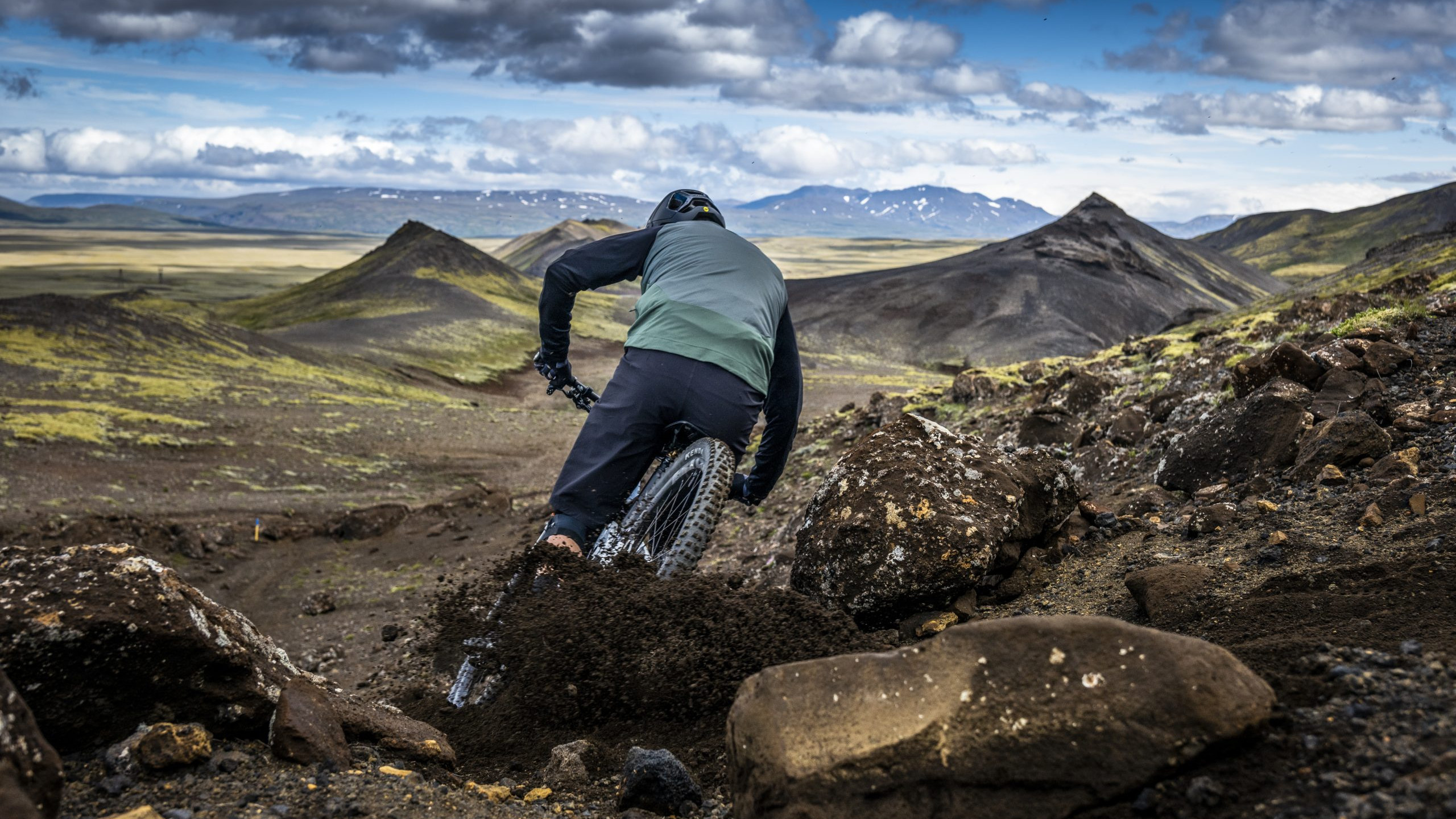 Mountain biker riding down rocky terrain, capturing adventure spirit. Andrew Neethling Journey to The Centre of The Earth. Outdoor cycling exploration. Mountain Bike United.