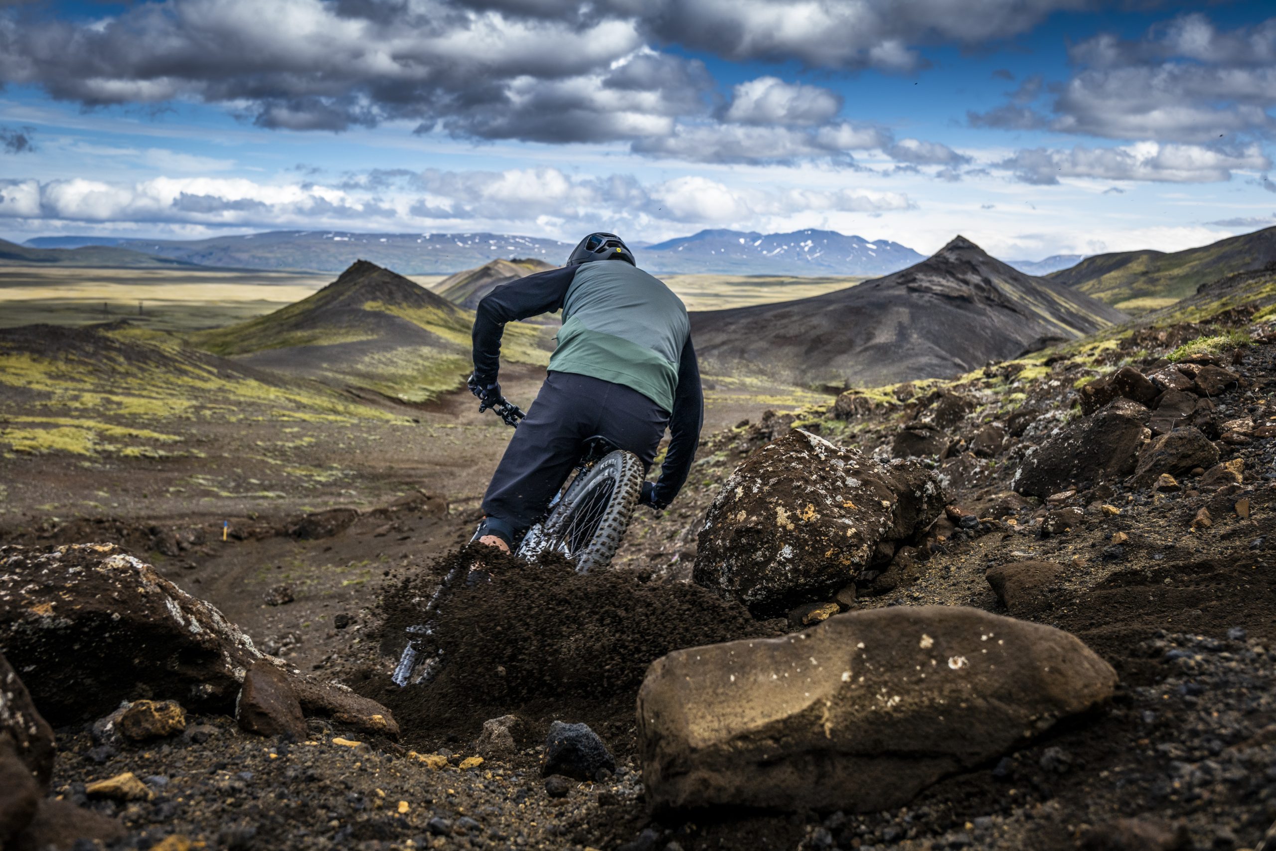 Mountain biker riding down rocky terrain, capturing adventure spirit. Andrew Neethling Journey to The Centre of The Earth. Outdoor cycling exploration. Mountain Bike United.