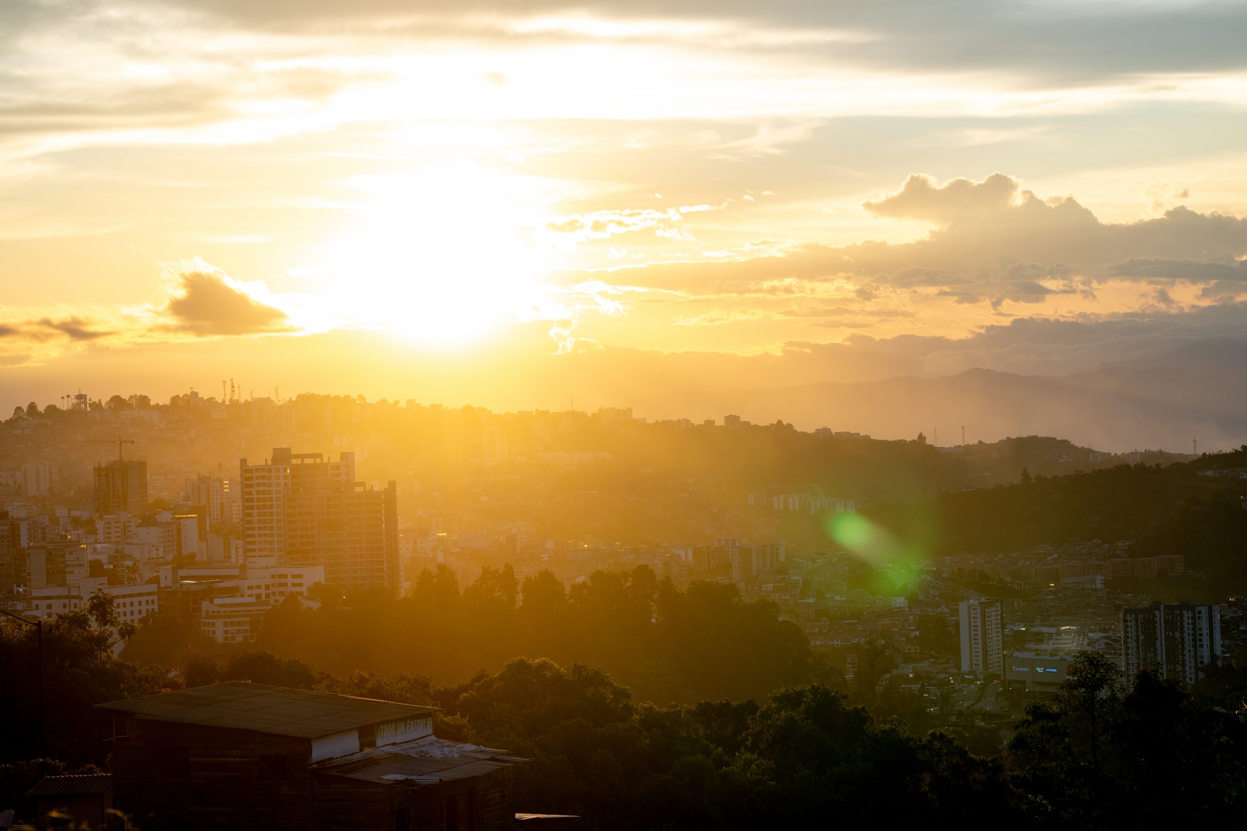 Sunset over Bogotá skyline, capturing the essence of Taste of Colombia. Scenic view perfect for Scotty Laughland's adventure backdrop. Mountain Bike United.