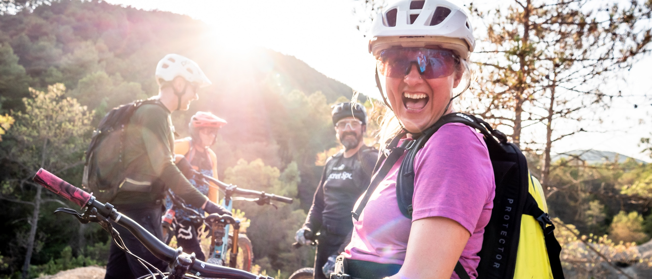 Mountain bikers enjoying a sunny day in nature, highlighting enthusiasm and camaraderie. Perfect setting to organise MTB event activities. Mountain Bike United. Organise MTB event. Organising MTB race. Organise MTB festival. Plan and promote MTB event. Plan and promote MTB race.