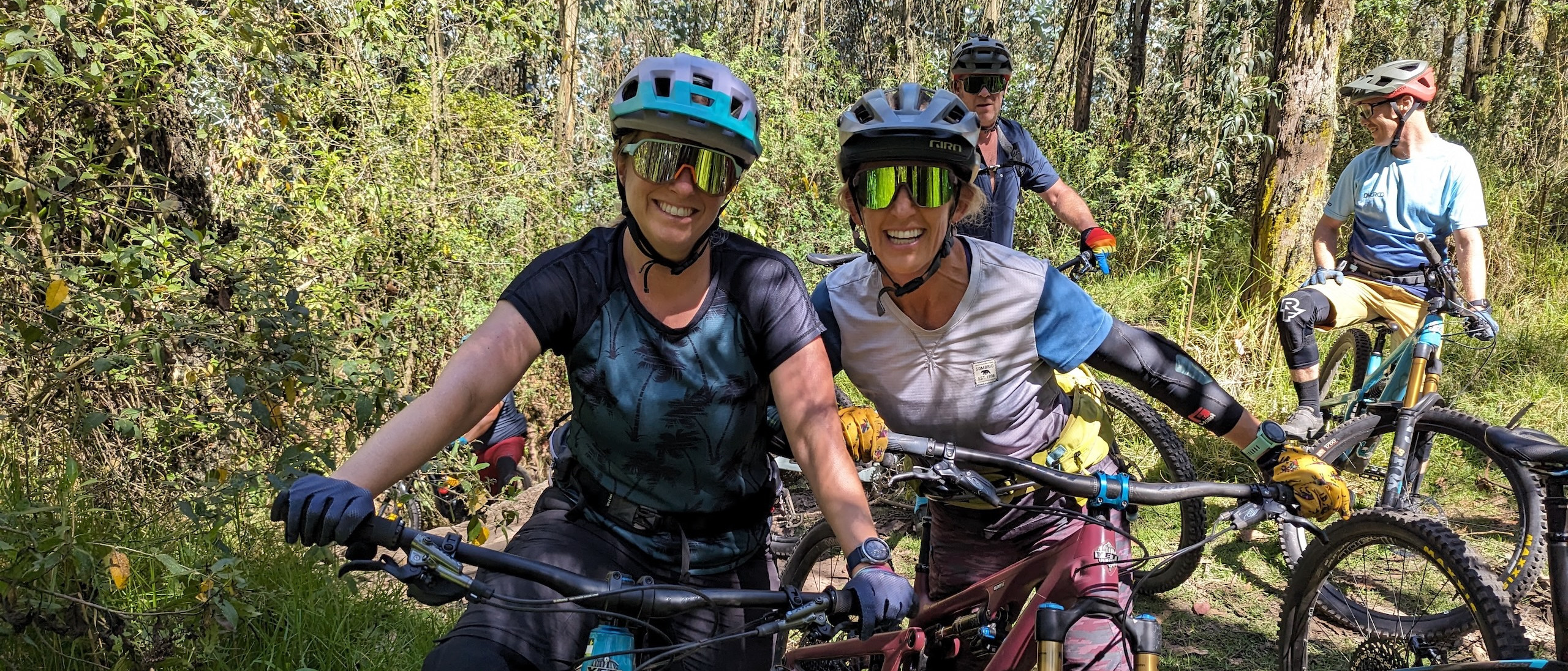 Group of mountain bikers enjoying a ride on managed trails in a forest setting, showcasing effective management of mountain bike trails. Mountain Bike United app. Manage mountain bike trails. Fund mountain bike trails. Manage trail volunteers. Control route updates. Mountain bike dig days.