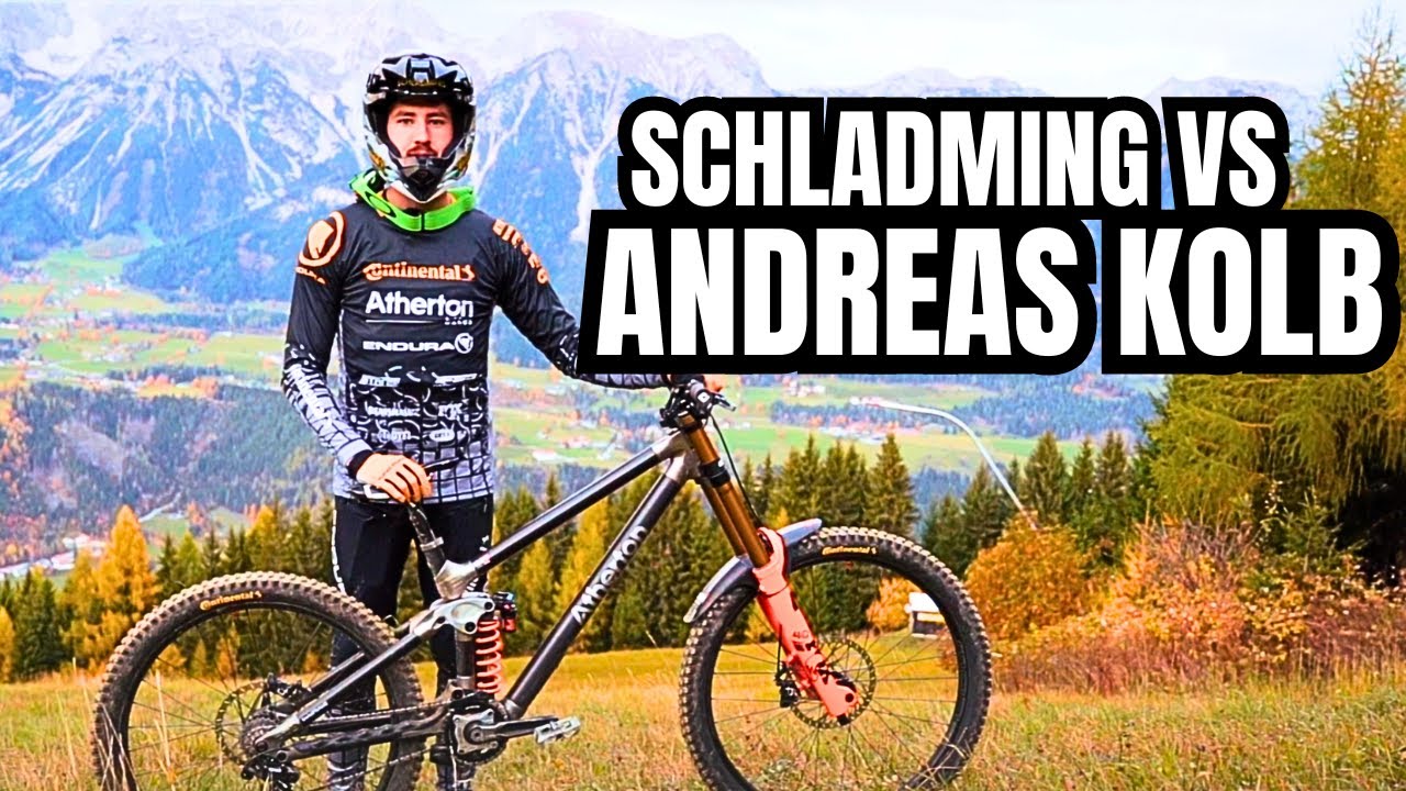 Mountain biker on hilltop with his bike, Schladming, and Andreas Kolb text. Keywords: Stefan Garlicki, Andreas Kolb, biking. Mountain Bike United.