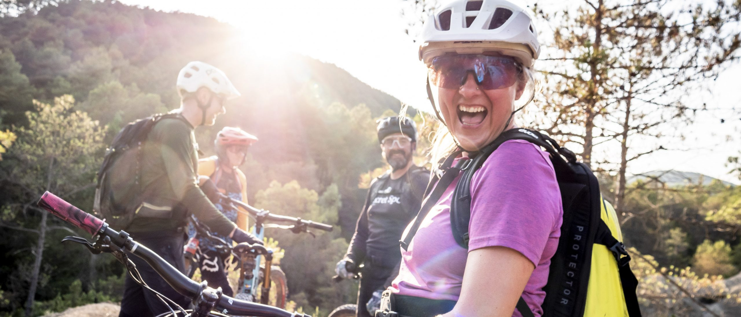 Group of cyclists enjoying a scenic ride in the Pyrenees with H+I Adventures. Mountain Bike United.