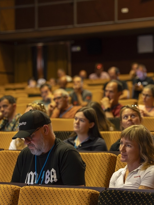 Attendees at IMBA Europe Summit 2025 in a conference hall. Mountain Bike United.