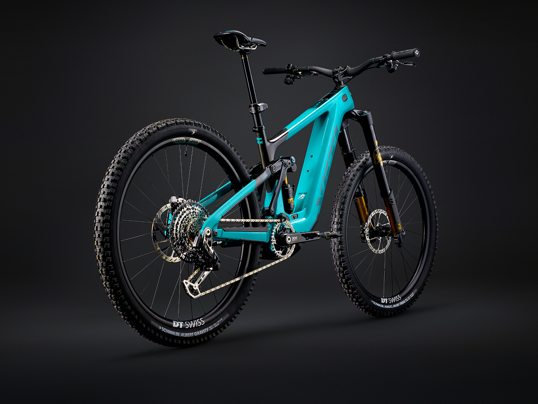 Teal mountain bike showcasing high-end components. Essential for mountain bike industry tools and repair guides. Features detailed suspension and tire treads. Mountain Bike United.