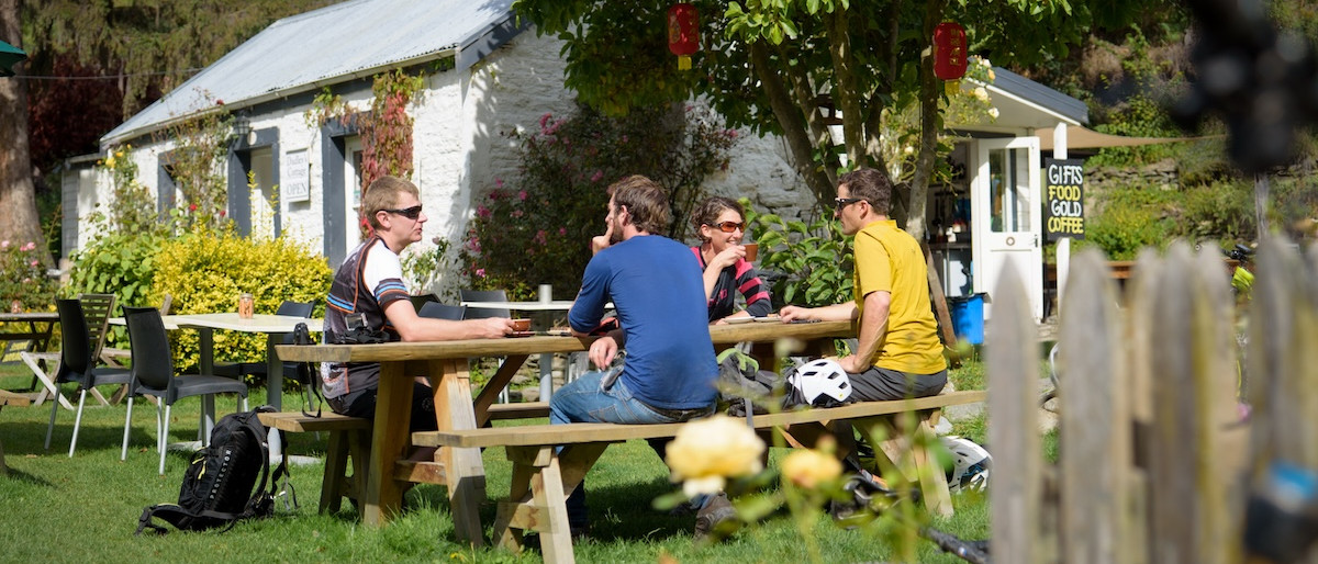 Group relaxing at a café near mountain bike trails. Mountain Bike United.