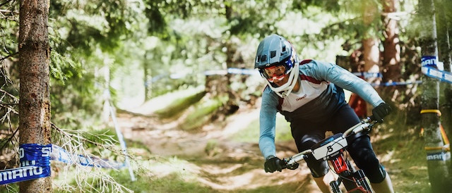 Female mountain biker racing in the Dolomites, Italy. Mountain Bike United.